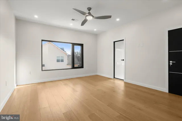 an empty room with windows and closet