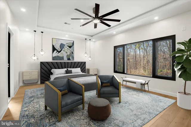 a bedroom with furniture and a large window