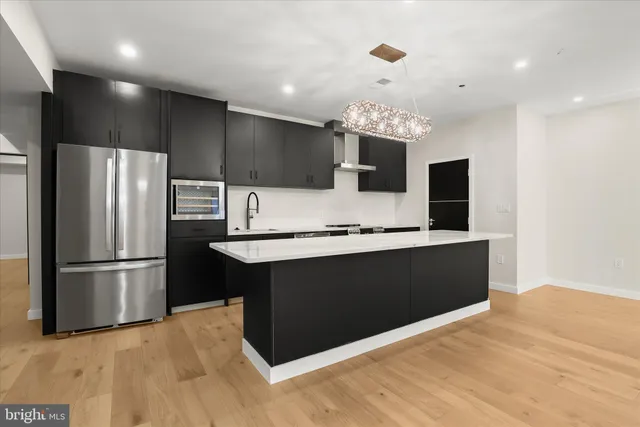an empty room with wooden floor and natural light