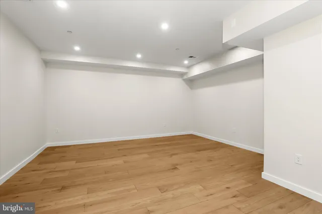 a view of a backyard with potted plants and large tree