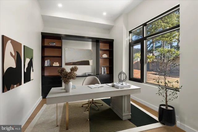 an empty room with a window and wooden floor