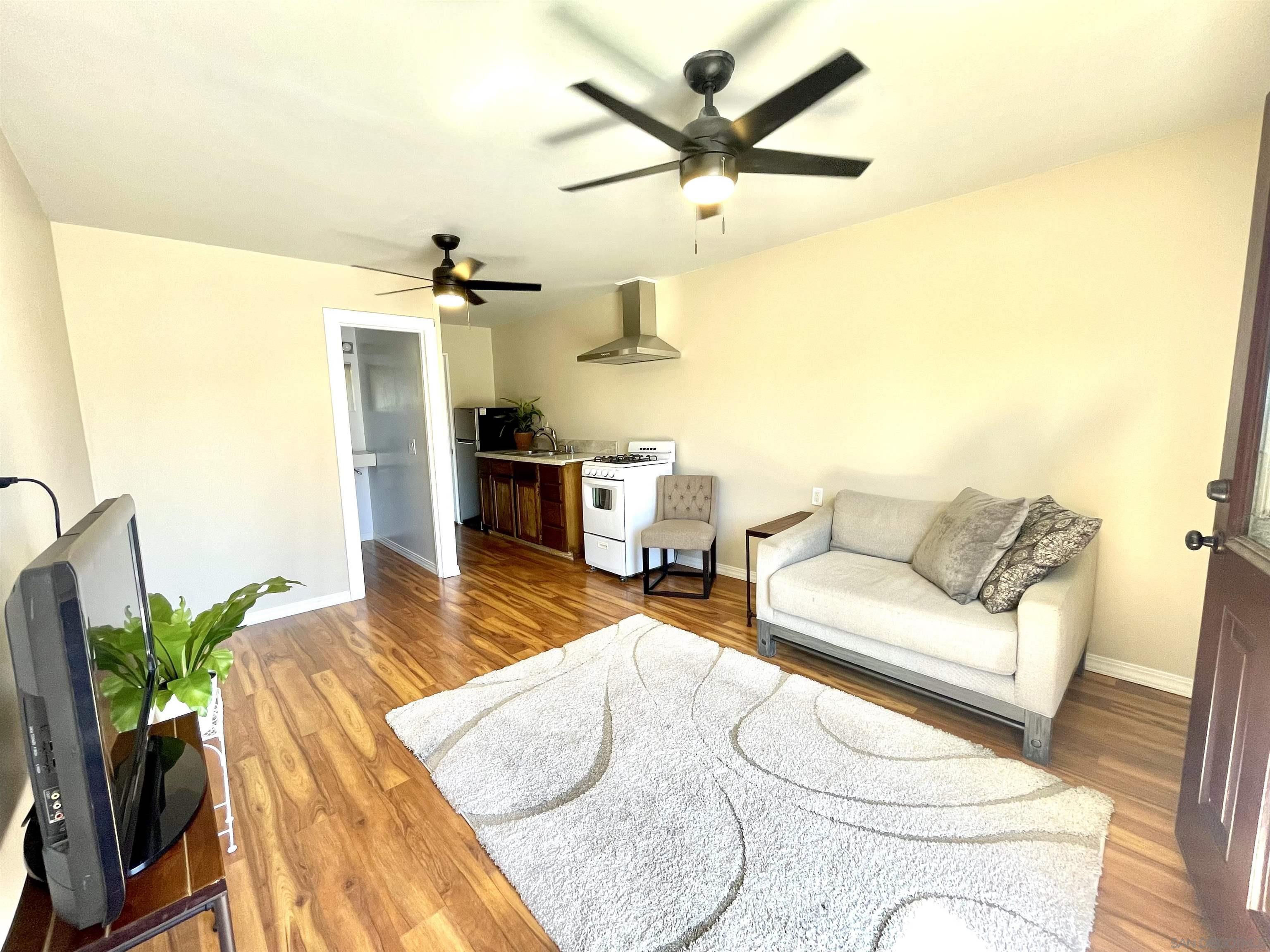 1221 Rees Road Escondido, CA 92026 - Photo 4 of 7 a living room with furniture and a view of kitchen