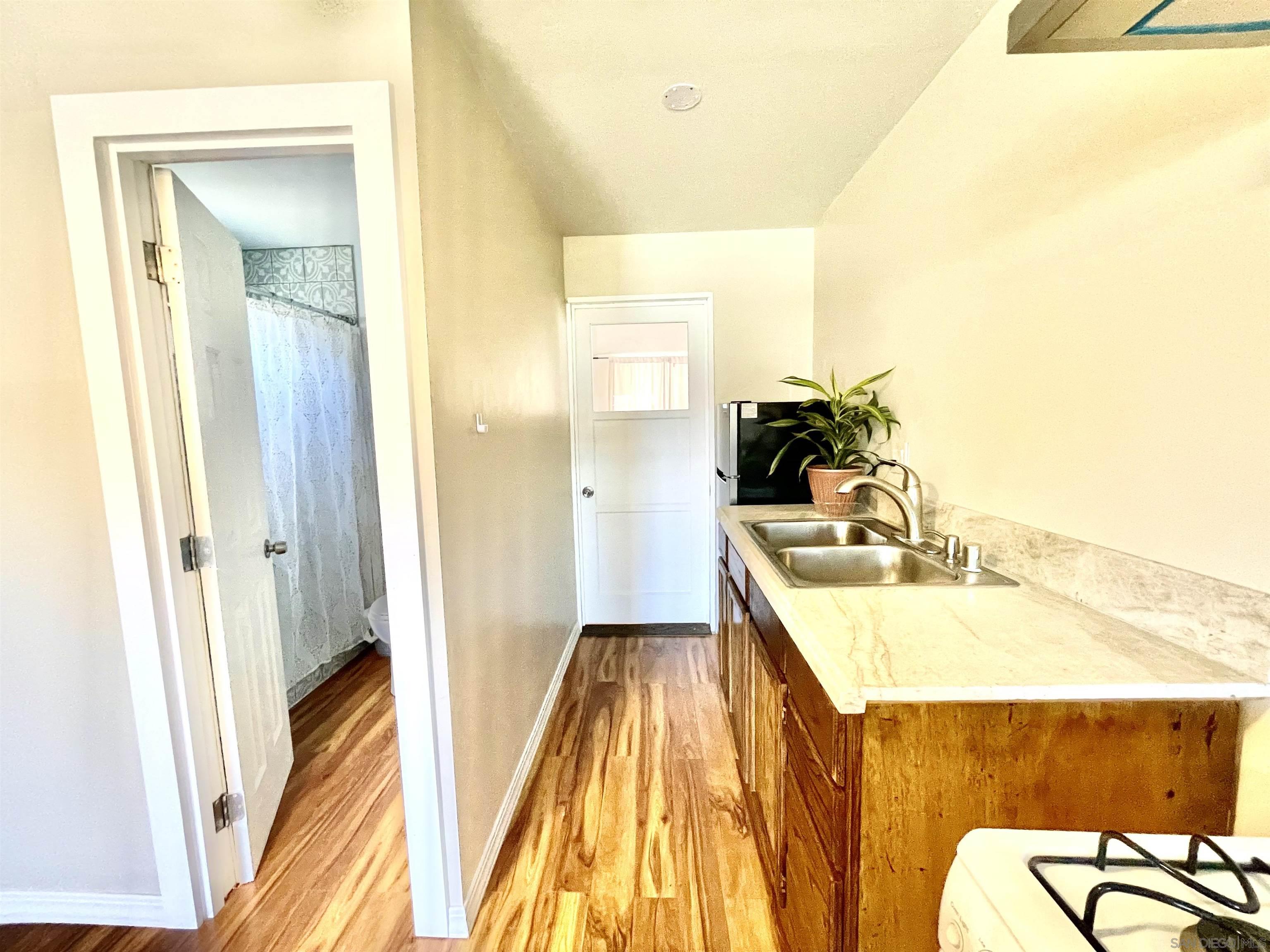 1221 Rees Road Escondido, CA 92026 - Photo 5 of 7 a bathroom with a sink a mirror and a bathtub