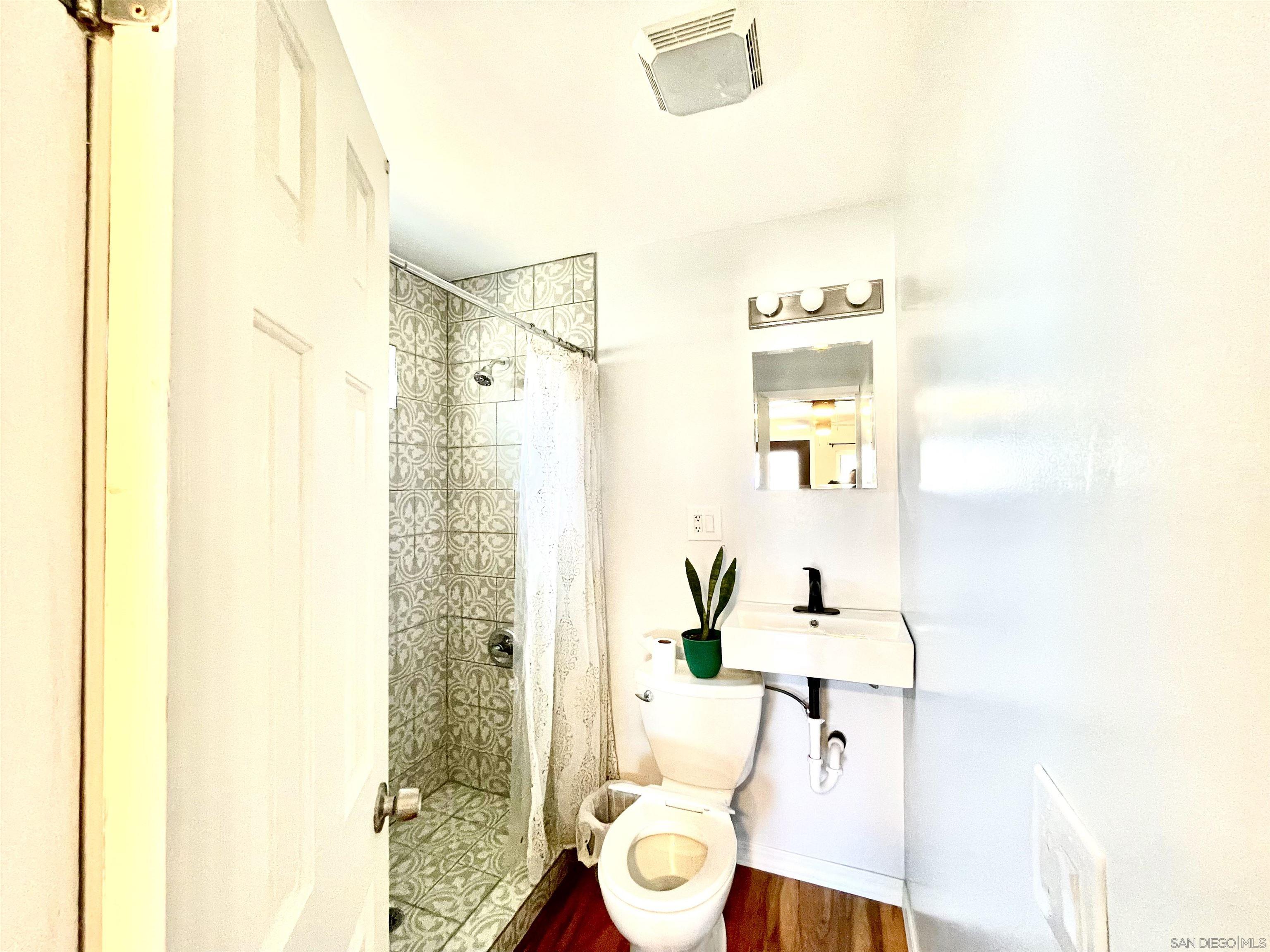 1221 Rees Road Escondido, CA 92026 - Photo 6 of 7 a bathroom with a sink and a mirror