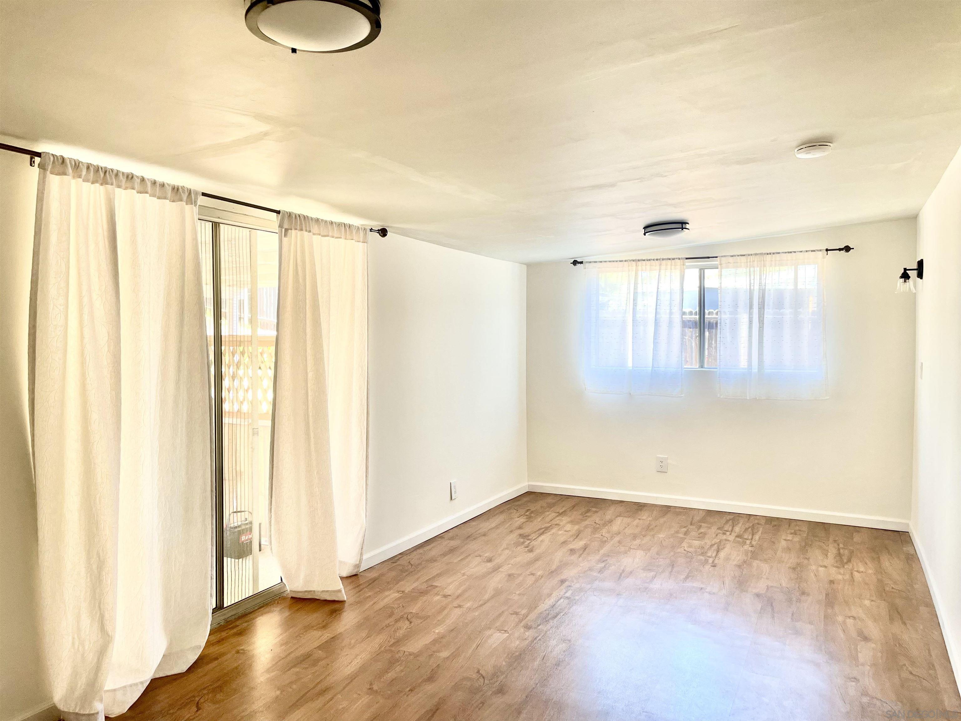 1221 Rees Road Escondido, CA 92026 - Photo 7 of 7 a view of a room with wooden floor and windows