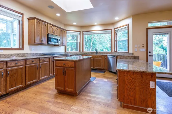 a kitchen with wooden floors and wooden cabinets