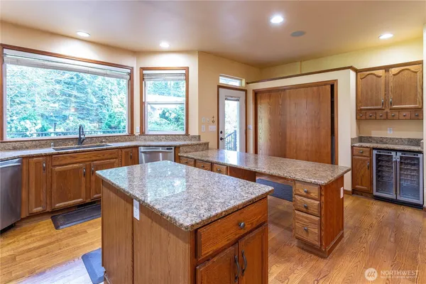 a kitchen with granite countertop sink stove and refrigerator