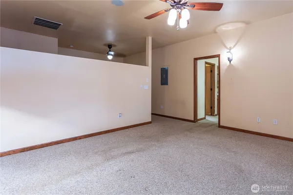 a view of a room with a ceiling fan