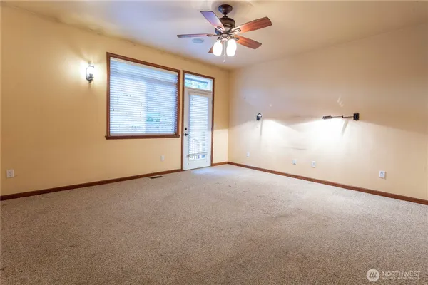 a view of a livingroom with a ceiling fan and window