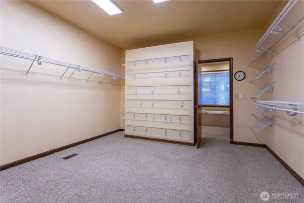 a view of walk in closet with clothes