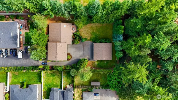 an aerial view of a house with pool garden and outdoor seating