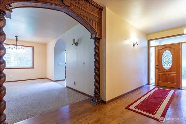 a view of an entryway with wooden floor