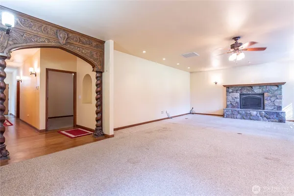 wooden floor in a room with a fireplace and a chandelier