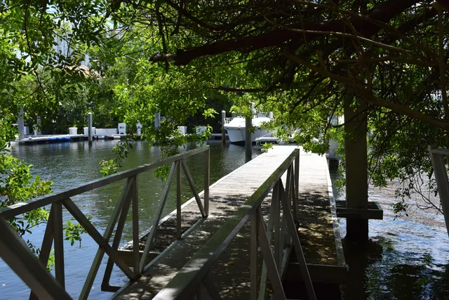 a view of a balcony with wooden floor and fence