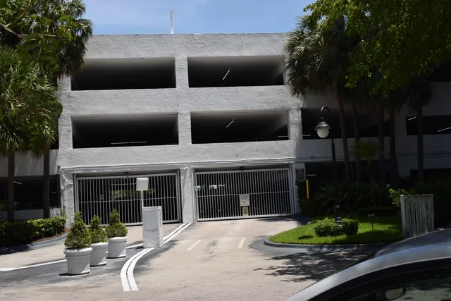 a front view of a house with a yard and potted plants
