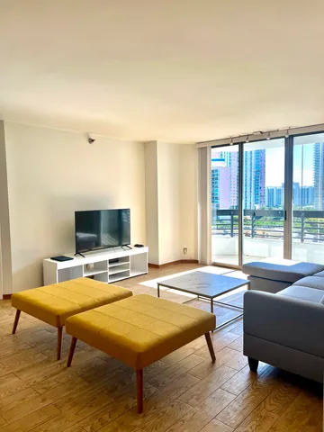 a living room with furniture pool table and a flat screen tv