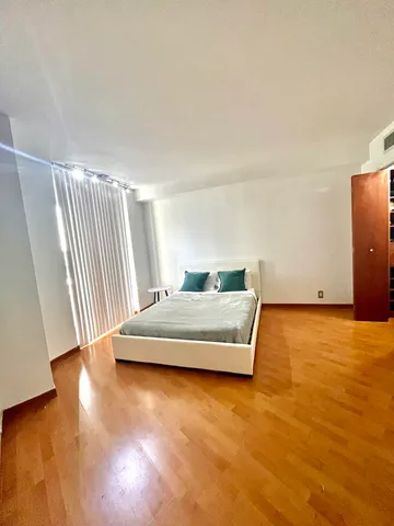 a living room with hard wood floors and a couch