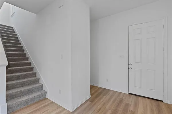 a view of an entryway with wooden floor