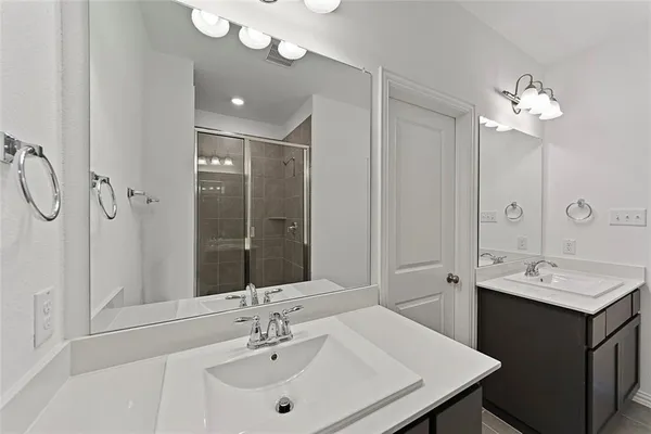 a bathroom with a sink double vanity and a mirror