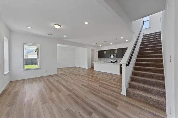 a view of entryway and hall with wooden floor