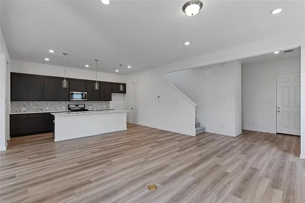 a view of kitchen with microwave and cabinets