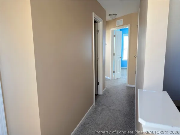 a view of a hallway with a room
