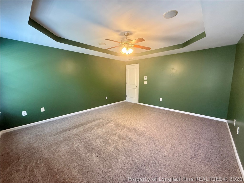 144 Bicentennial Way Cameron, NC 28326 - Photo 12 of 23 en empty room with windows and ceiling fan