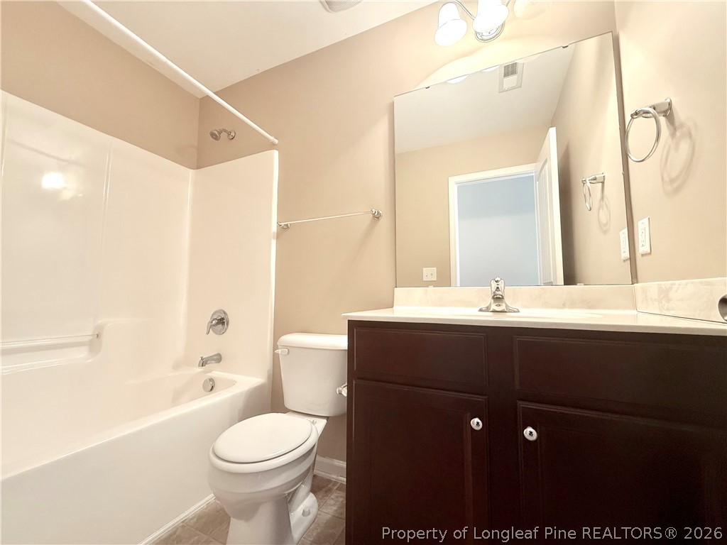 144 Bicentennial Way Cameron, NC 28326 - Photo 18 of 23 a bathroom with a sink toilet mirror and shower