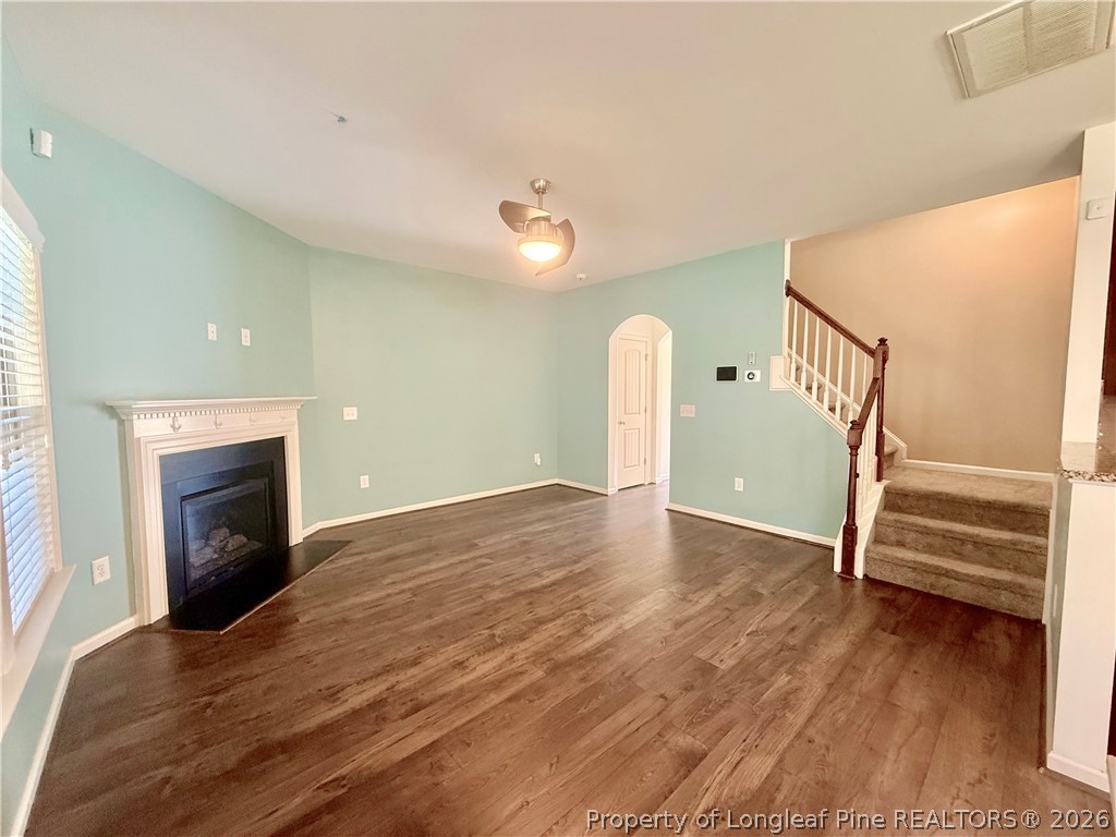 144 Bicentennial Way Cameron, NC 28326 - Photo 4 of 23 a view of empty room with stairs and wooden floor