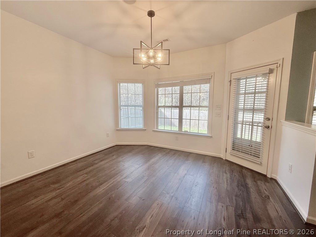 144 Bicentennial Way Cameron, NC 28326 - Photo 9 of 23 an empty room with wooden floor chandelier and windows