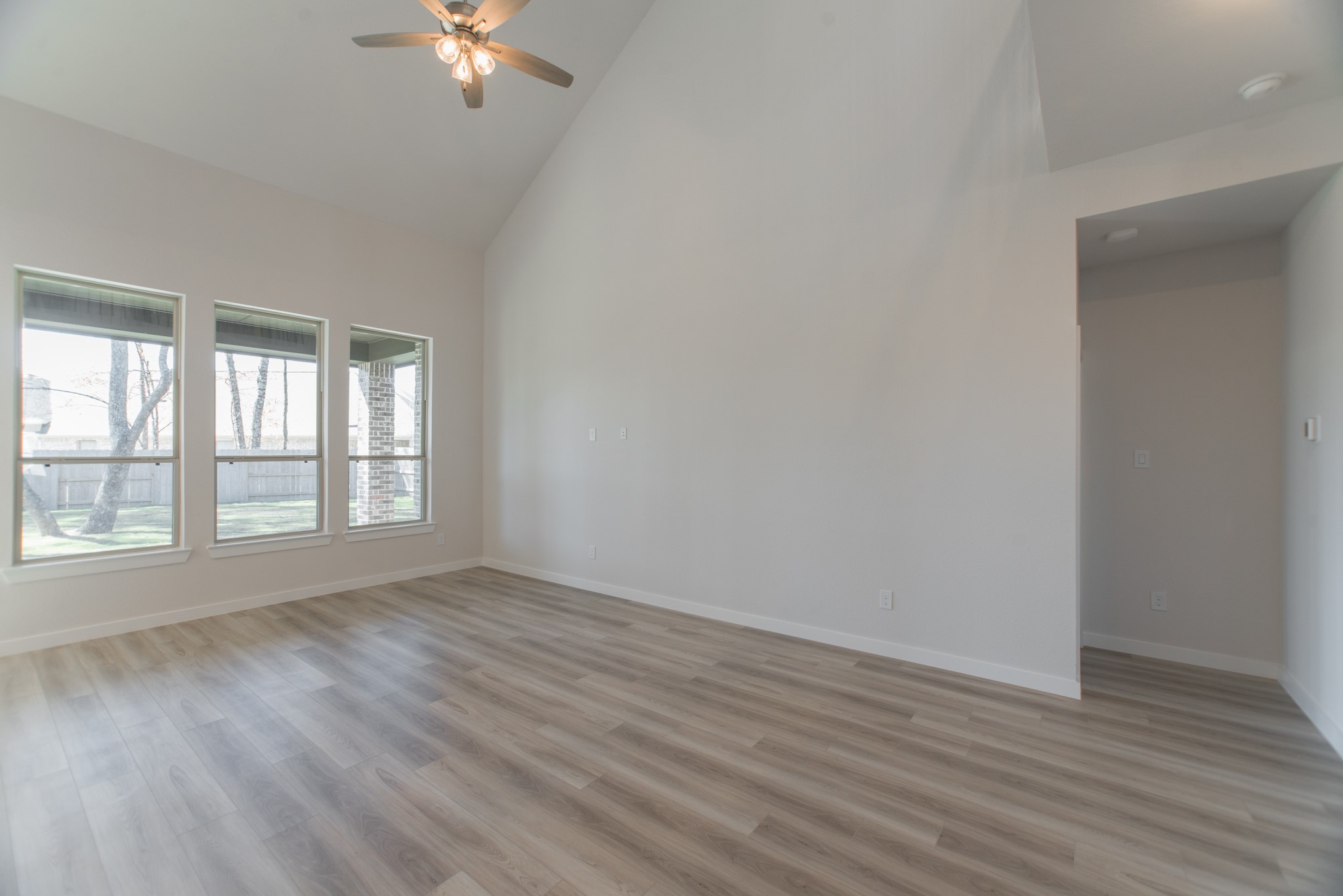 17138 Crimson Crest Drive Conroe, TX 77302 - Photo 15 of 50 a view of an empty room with wooden floor and a window