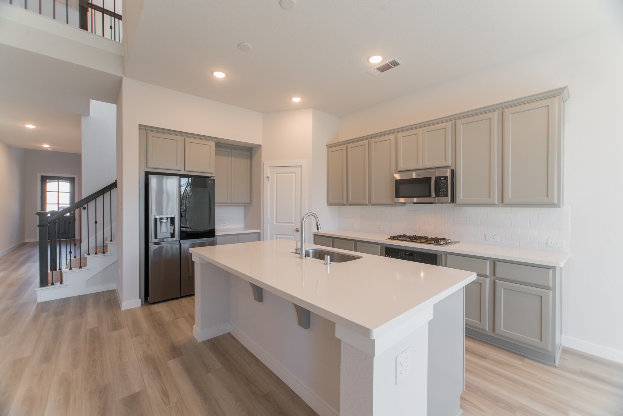 17138 Crimson Crest Drive Conroe, TX 77302 - Photo 18 of 50 a kitchen with white cabinets and stainless steel appliances