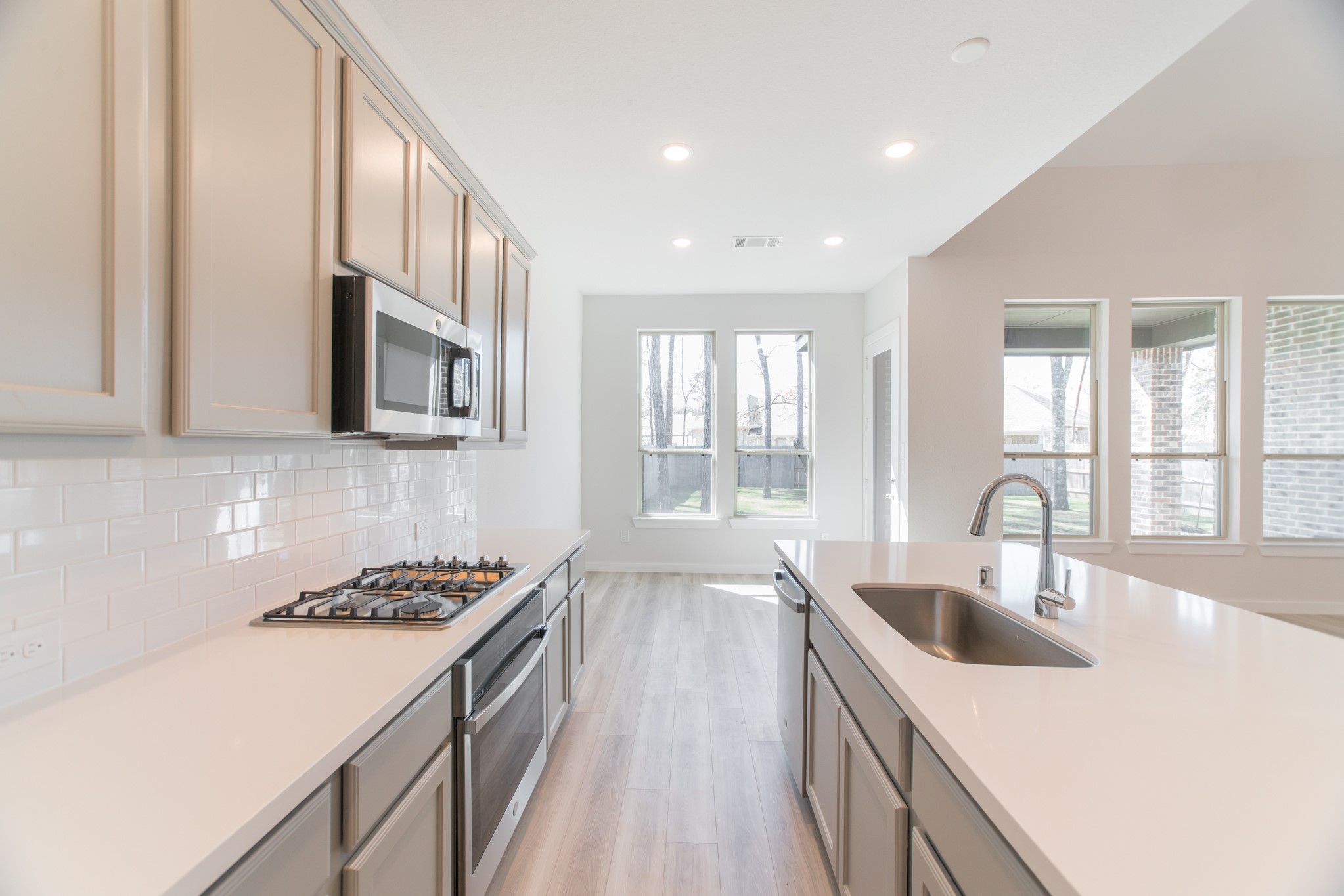 17138 Crimson Crest Drive Conroe, TX 77302 - Photo 20 of 50 a kitchen with stainless steel appliances granite countertop a sink stove and cabinets