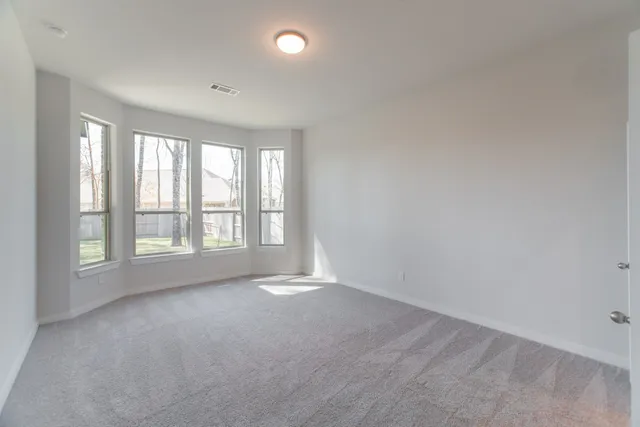 a view of an empty room and a window