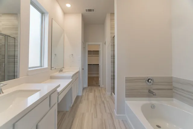 a bathroom with a double vanity sink mirror and