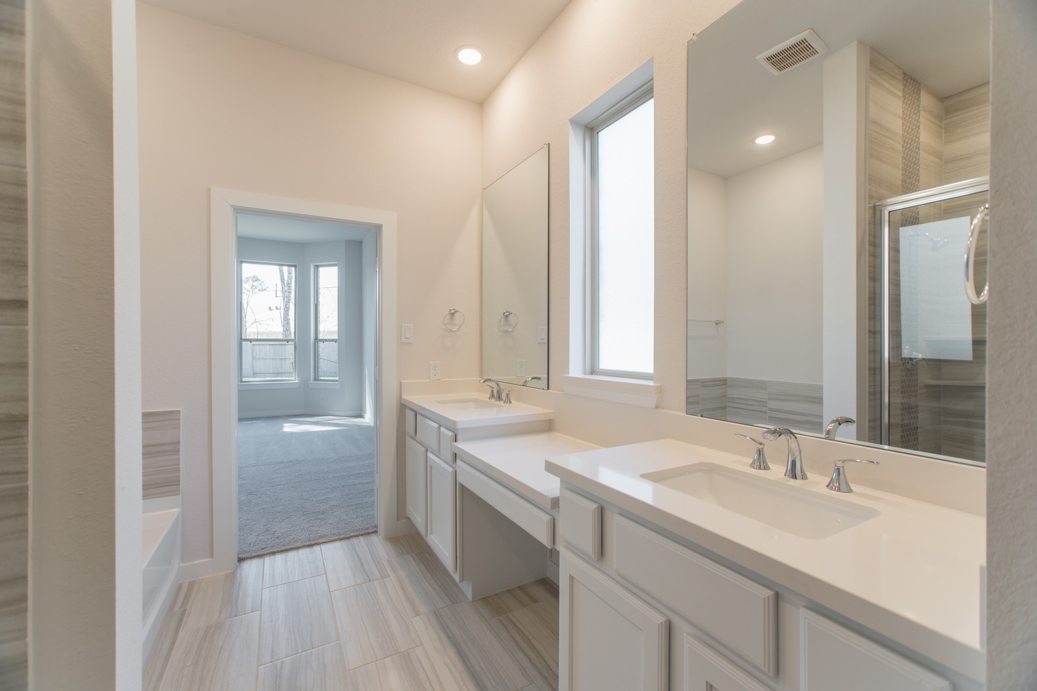 17138 Crimson Crest Drive Conroe, TX 77302 - Photo 25 of 50 a bathroom with a sink double vanity granite tub shower and a mirror