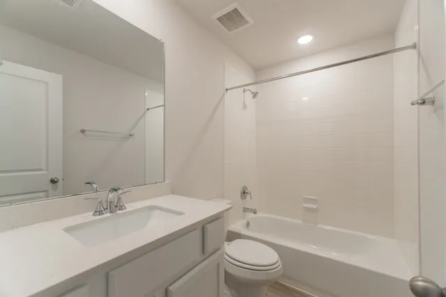 a view of staircase with railing and white walls