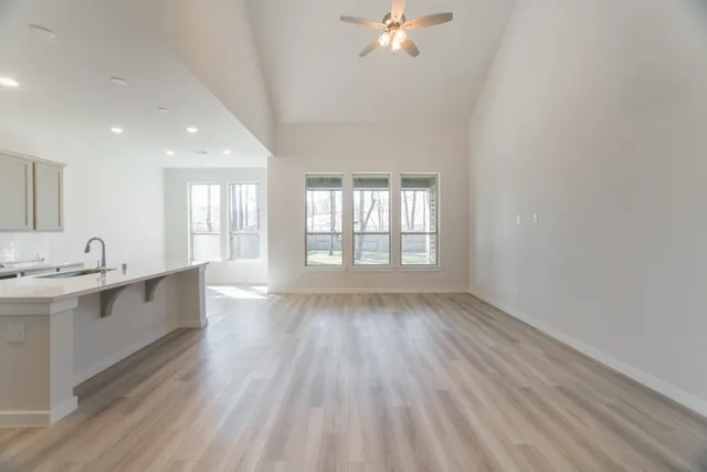 a view of kitchen and center island in wooden floor