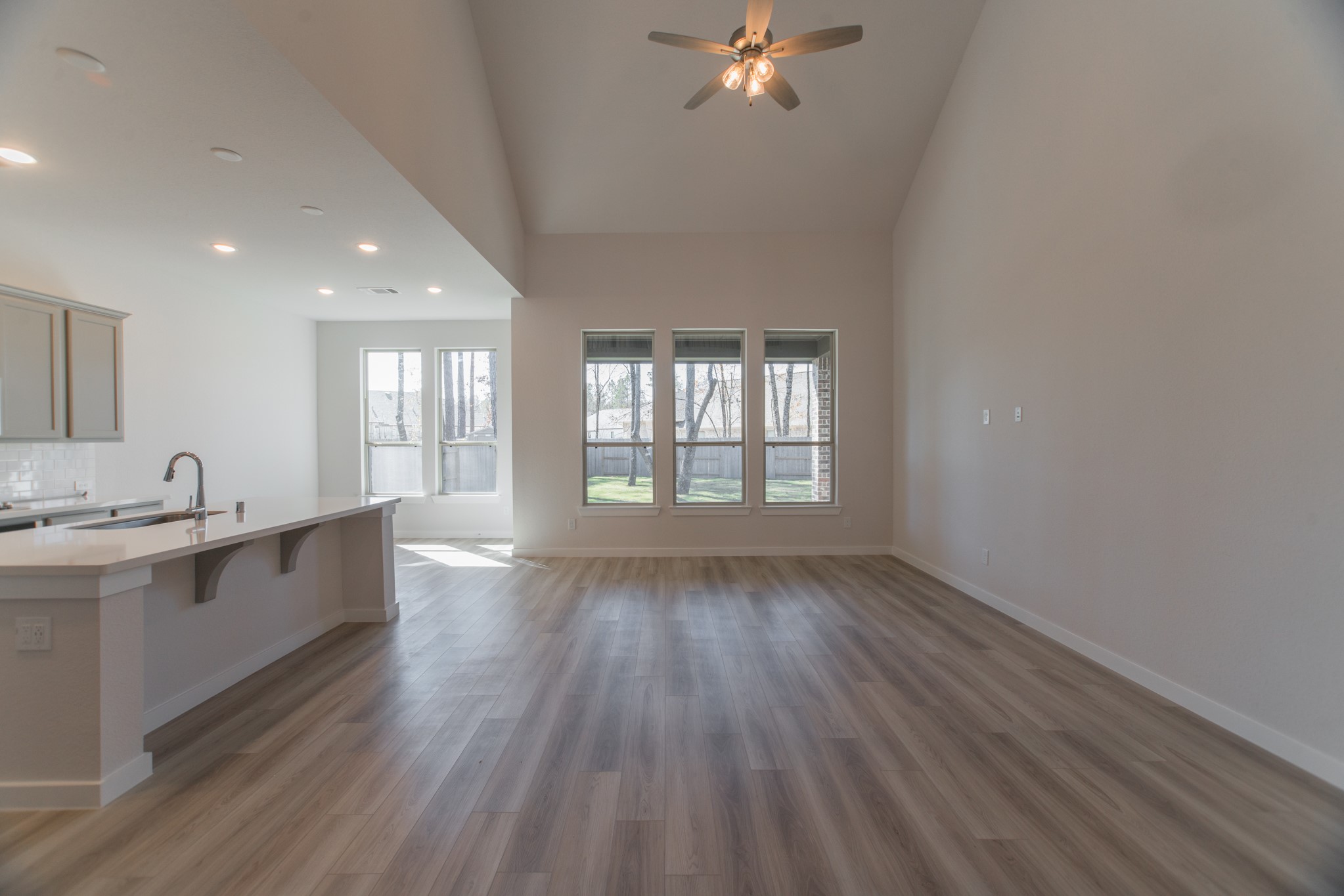 17138 Crimson Crest Drive Conroe, TX 77302 - Photo 9 of 50 a view of kitchen and center island in wooden floor