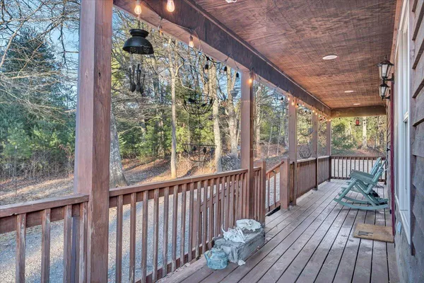 a balcony with chairs and wooden floor