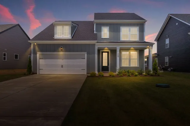 a front view of a house with a garden