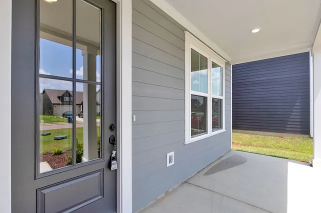 a view of a hallway with wooden floor and chandelier