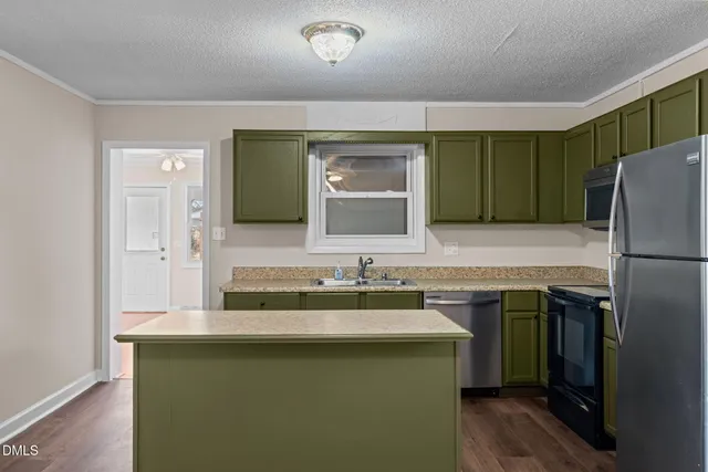 a kitchen with a refrigerator sink and microwave