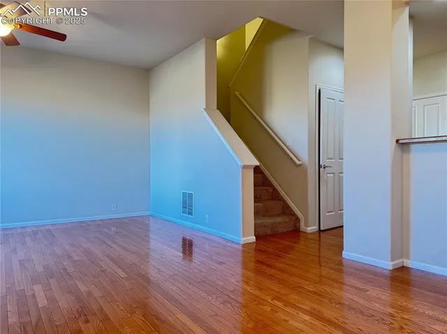 a view of a room with wooden floor