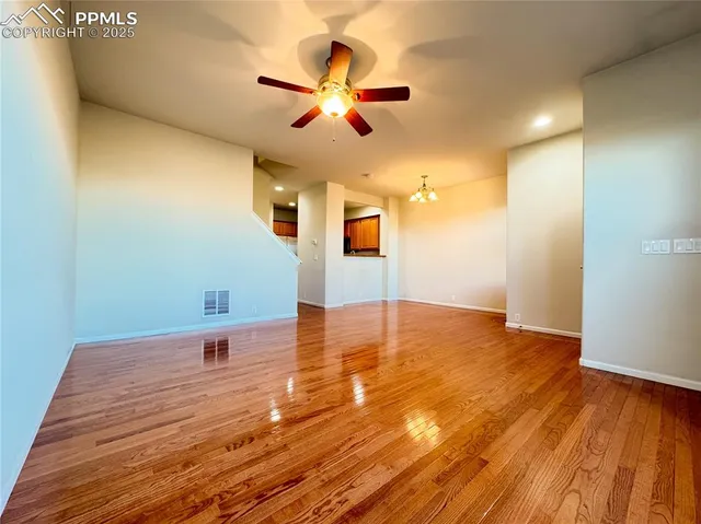 a kitchen with granite countertop a refrigerator stove and sink