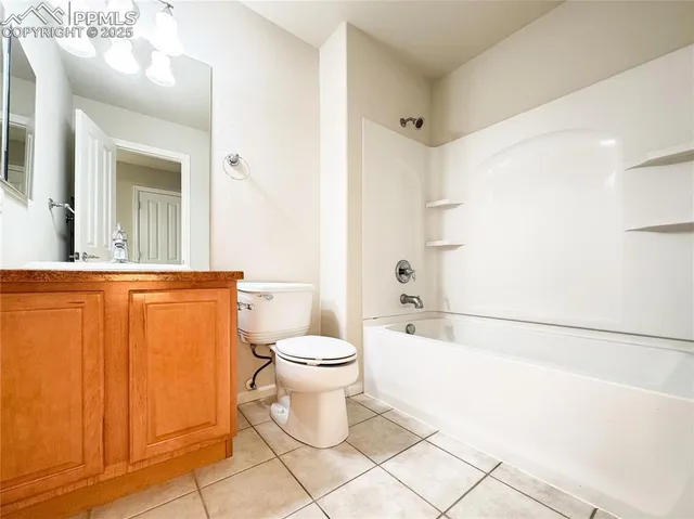 an empty room with a ceiling fan and a window