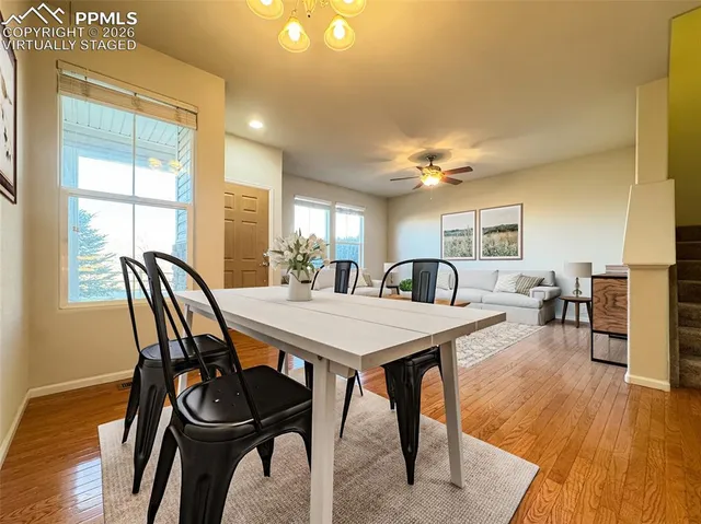 a view of a hallway with wooden floor and staircase