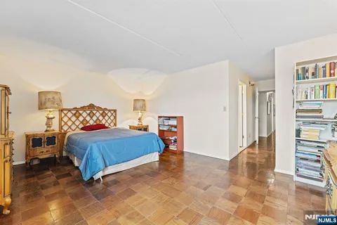 a bedroom with a bed and a book shelf