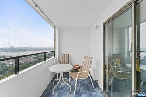 a view of a balcony dining table and chairs