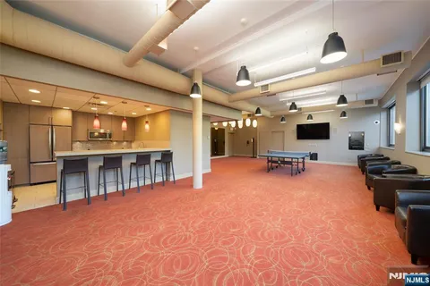 a dining room with furniture and a floor to ceiling window